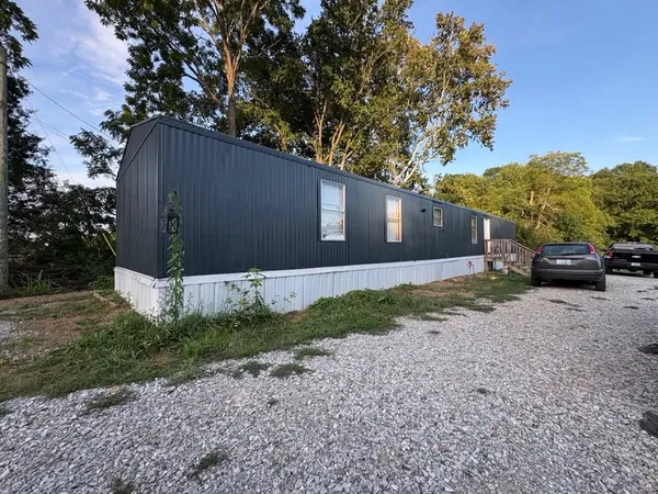 Mobile home exterior painted navy with white skirting