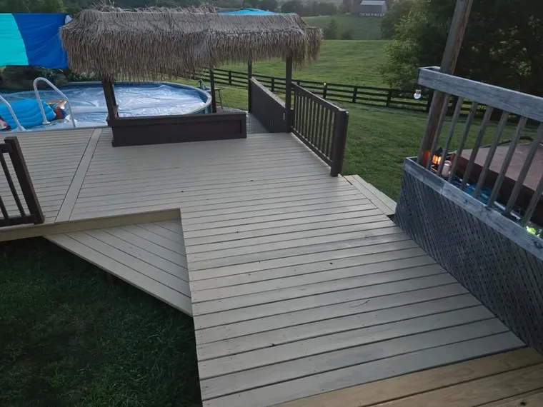 Pool deck painted tan with brown rails by We Paint It LLC