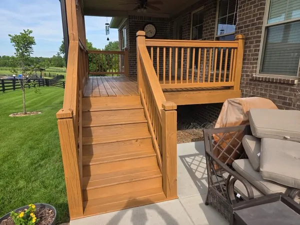 Wood porch and stairs freshly stained a warm cedar color